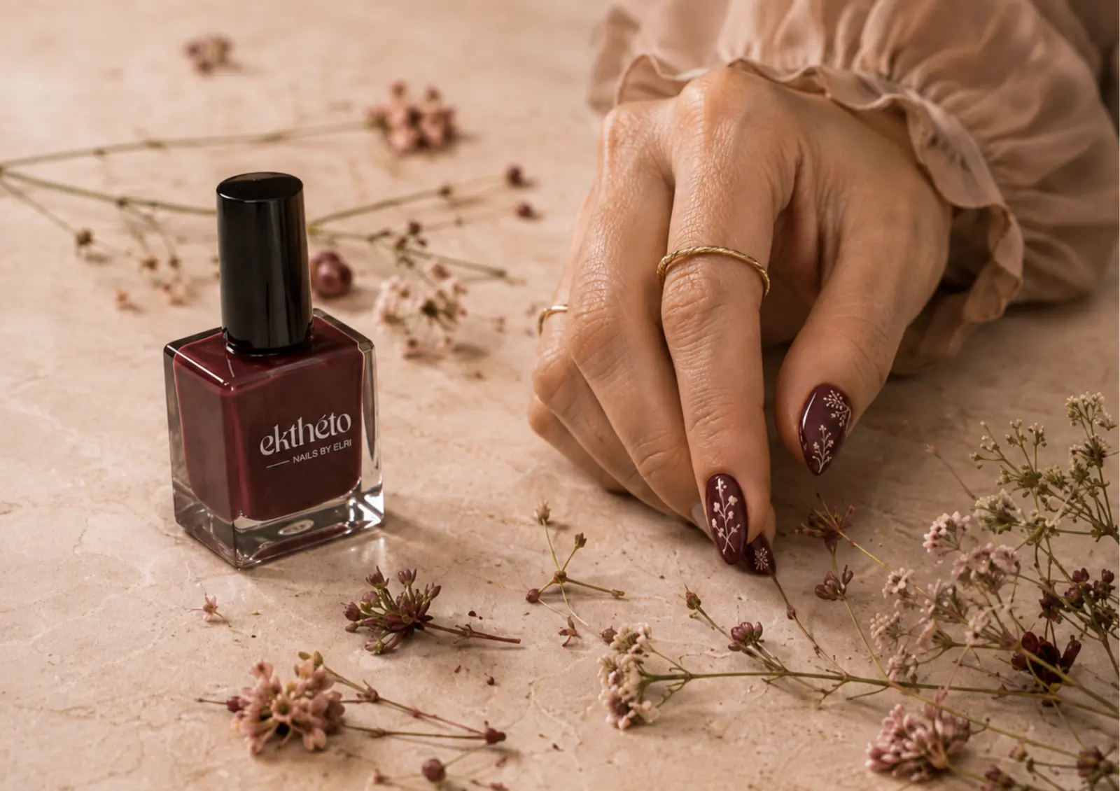 Burgundy manicure with delicate botanical nail art